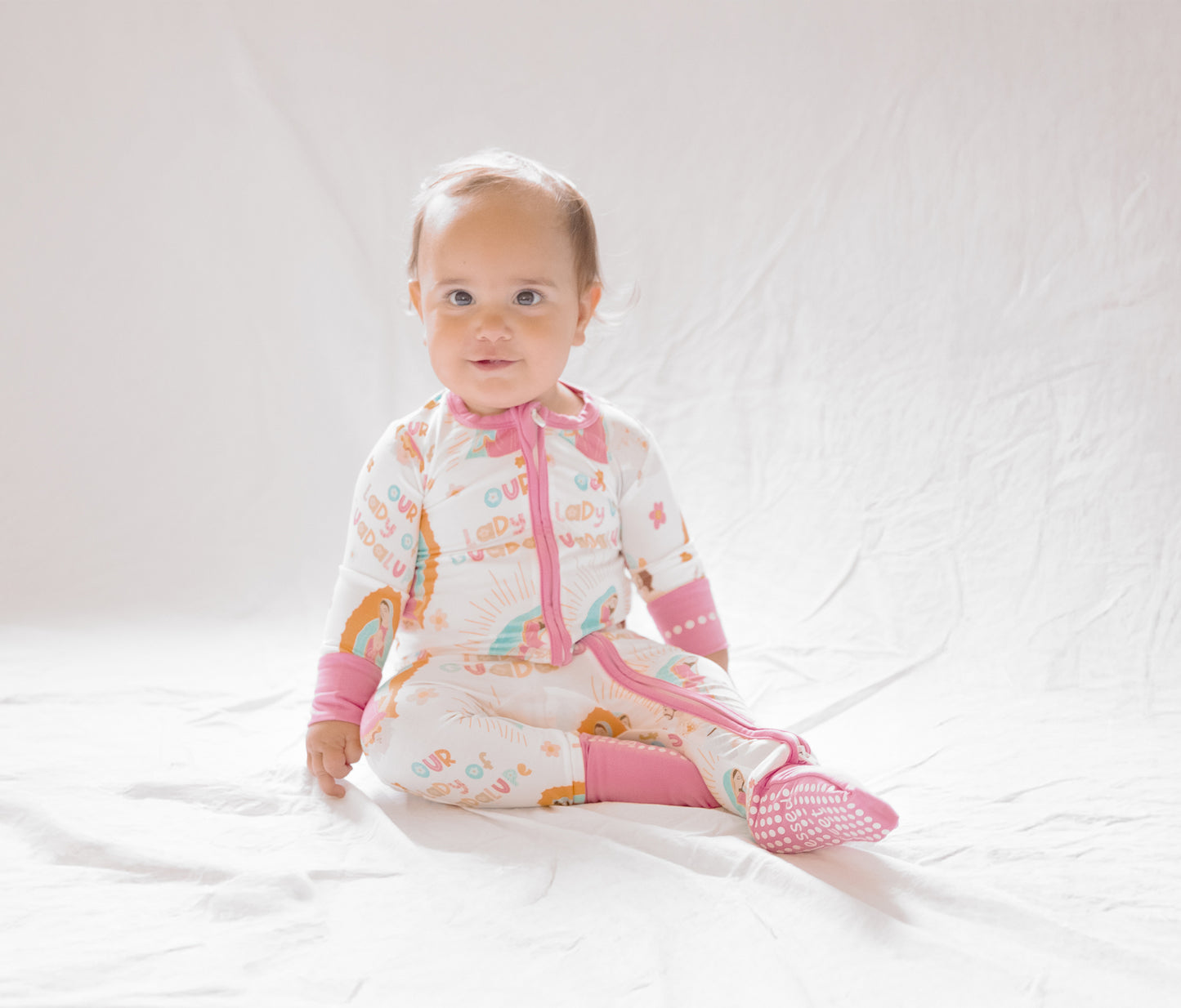 Baby girl wearing Our Lady of Guadalupe pajamas