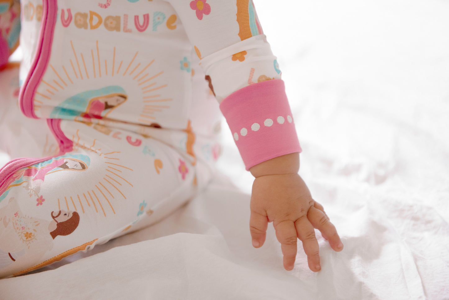 Rosary bead detailing on wrist of Our Lady of Guadalupe pajamas