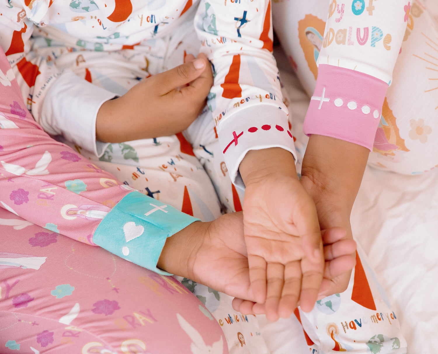 Children in Saint themed pajamas holding hands