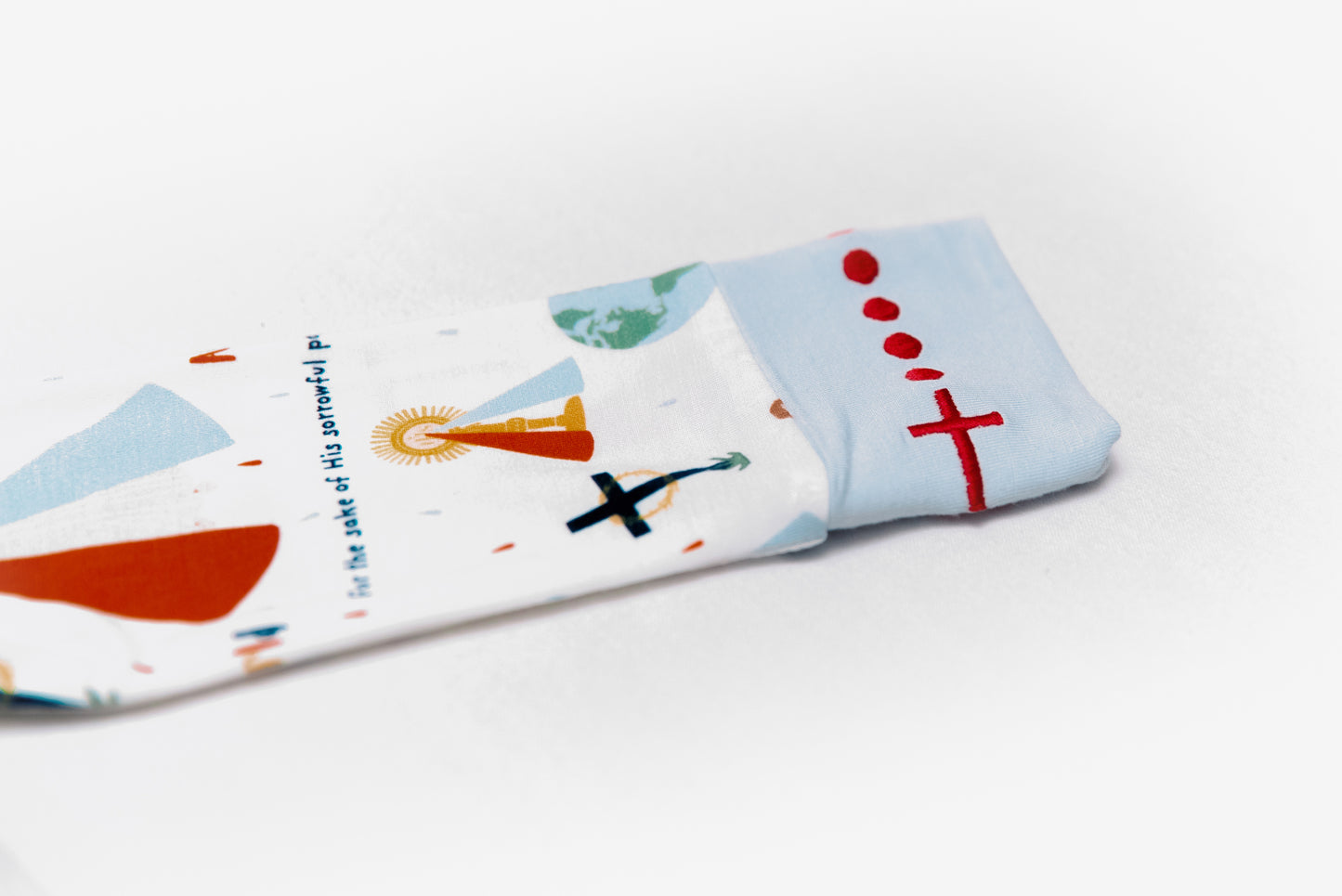 Embroidered rosary detail on wrist of Divine Mercy Catholic baby boy footie pajamas