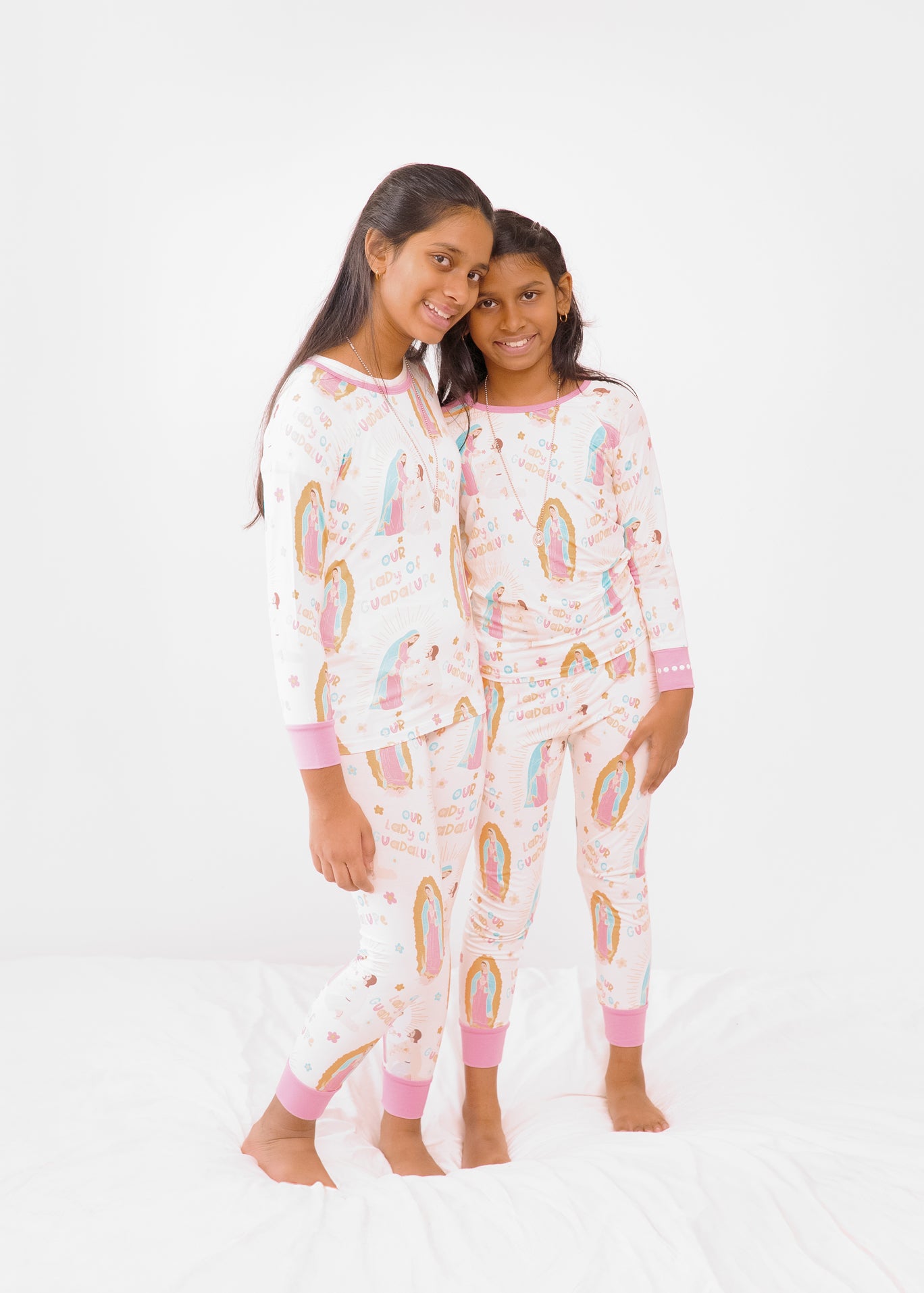Girls wearing matching Our Lady of Guadalupe Catholic pajamas