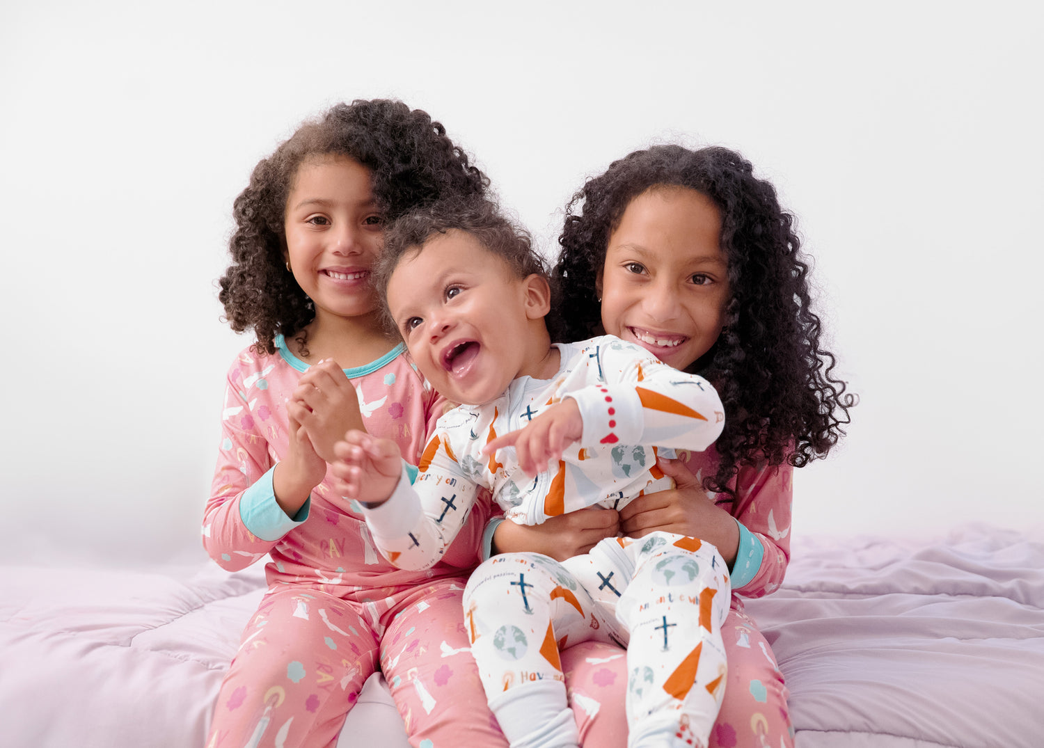 Girls and baby boy wearing Catholic family matching pajamas