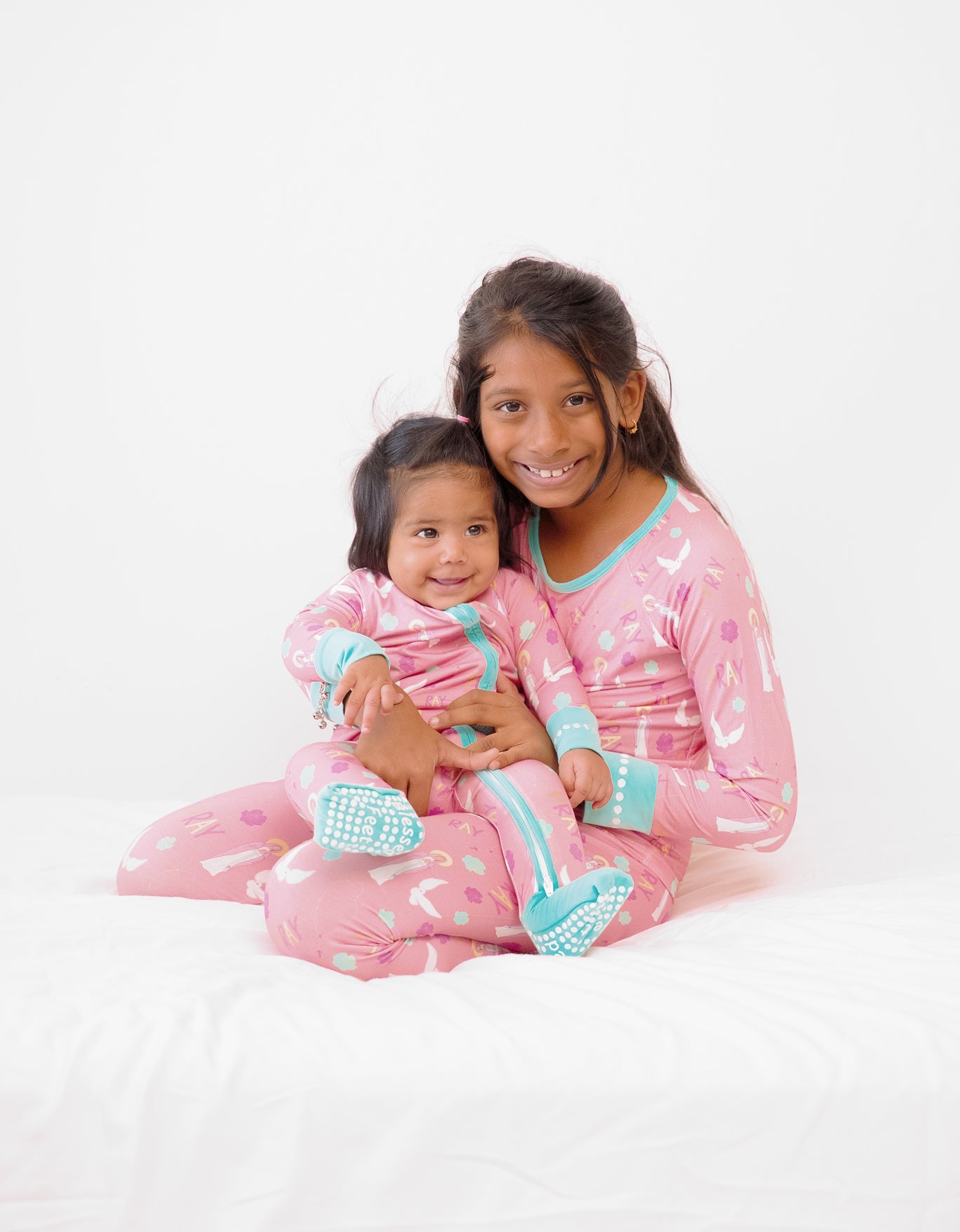 Girls wearing matching Catholic Pray Pajamas