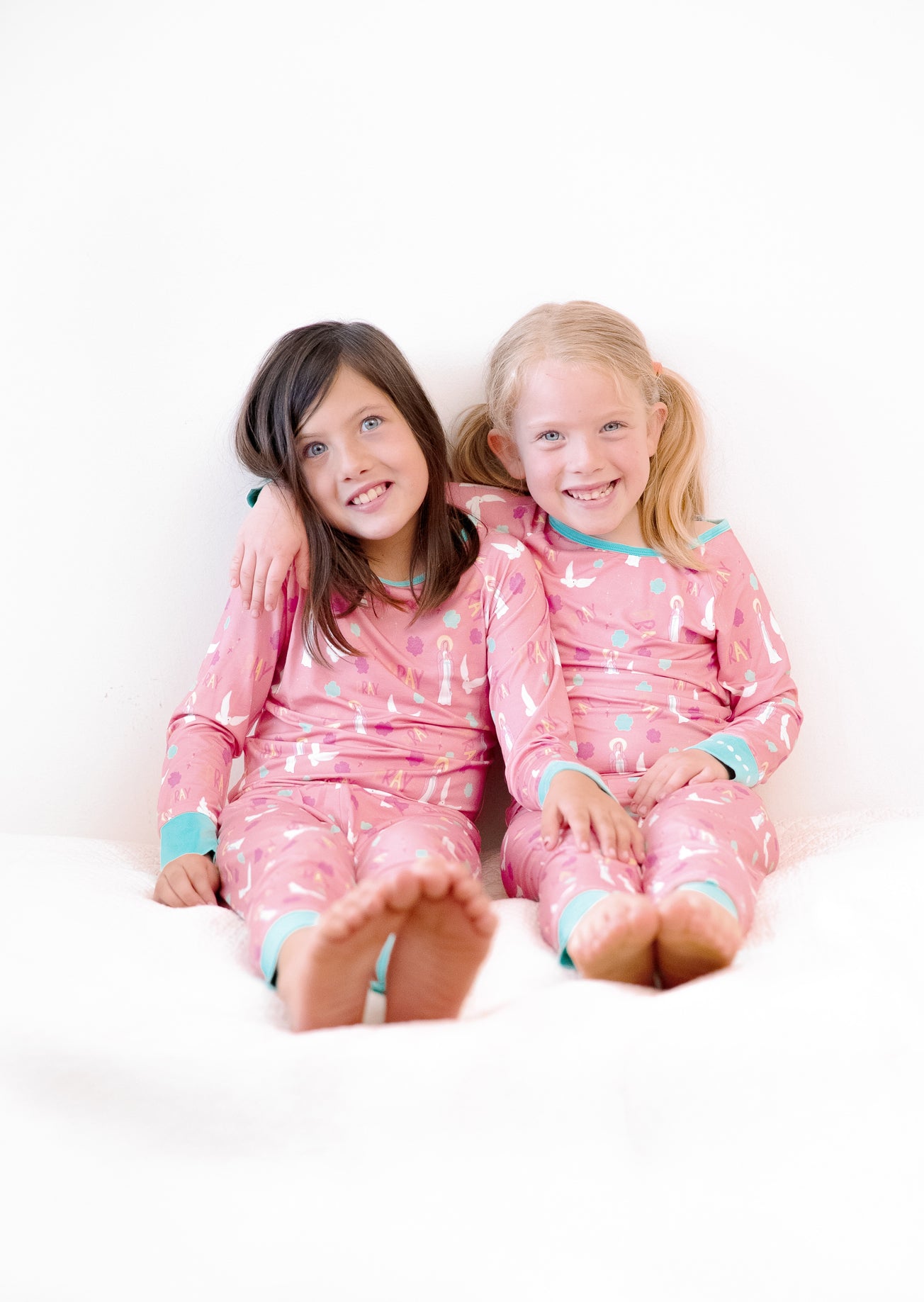 Girls wearing matching Catholic Pray Pajamas