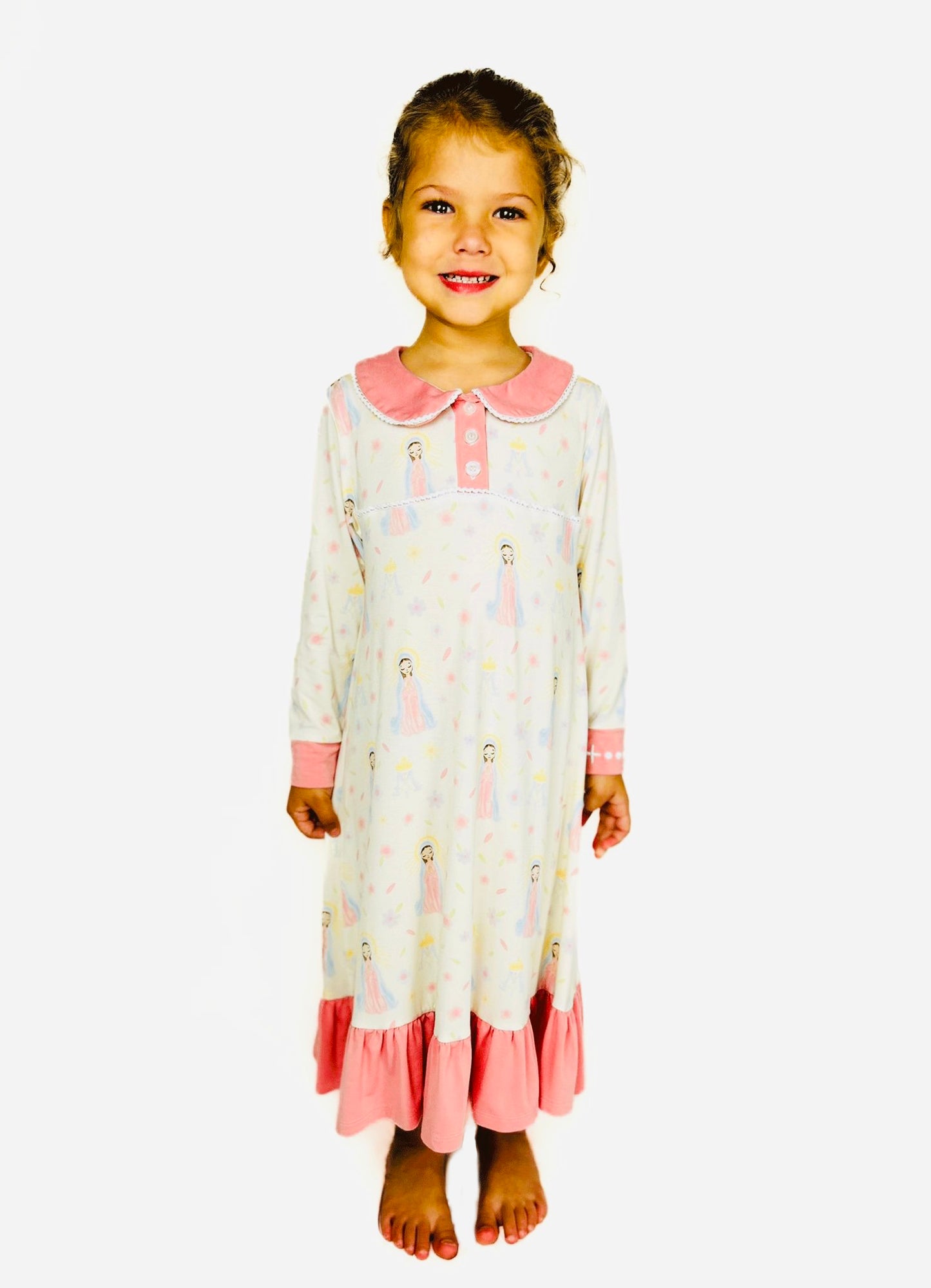 Girl wearing a Sweet Mary nightgown with pink accents on a white background