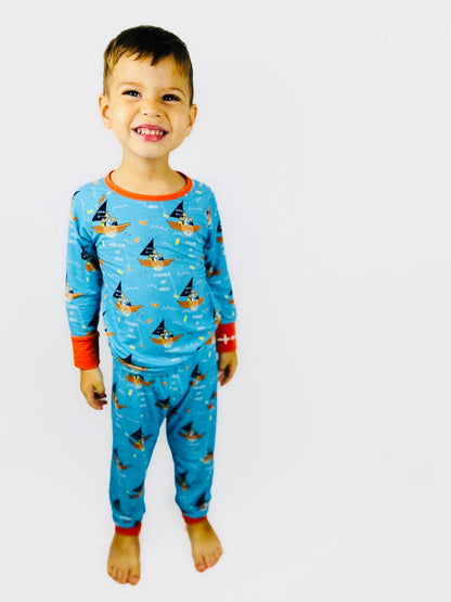 Boy wearing Catholic kids pajamas with disciples in boat with Jesus design and embroidered rosary wrist detail