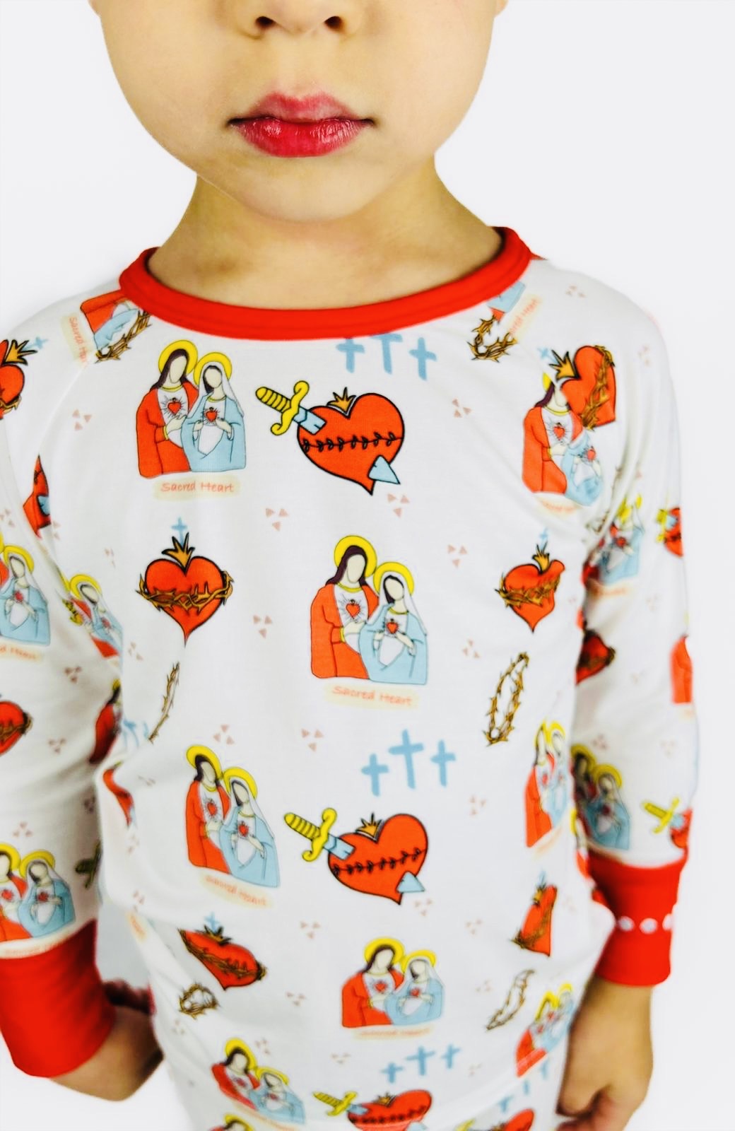 Boy wearing Sacred Heart of Jesus and Immaculate Heart of Mary pajamas 