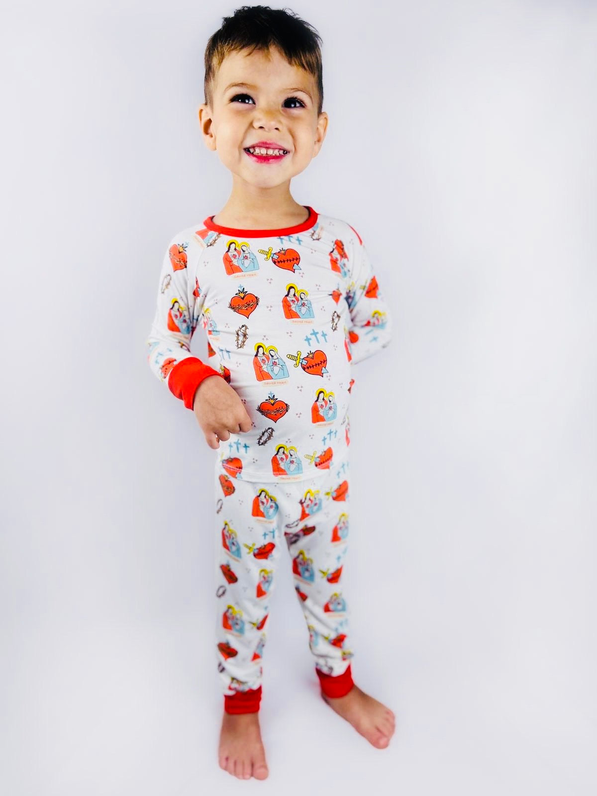 Boy wearing Sacred Heart of Jesus and Immaculate Heart of Mary pajamas 